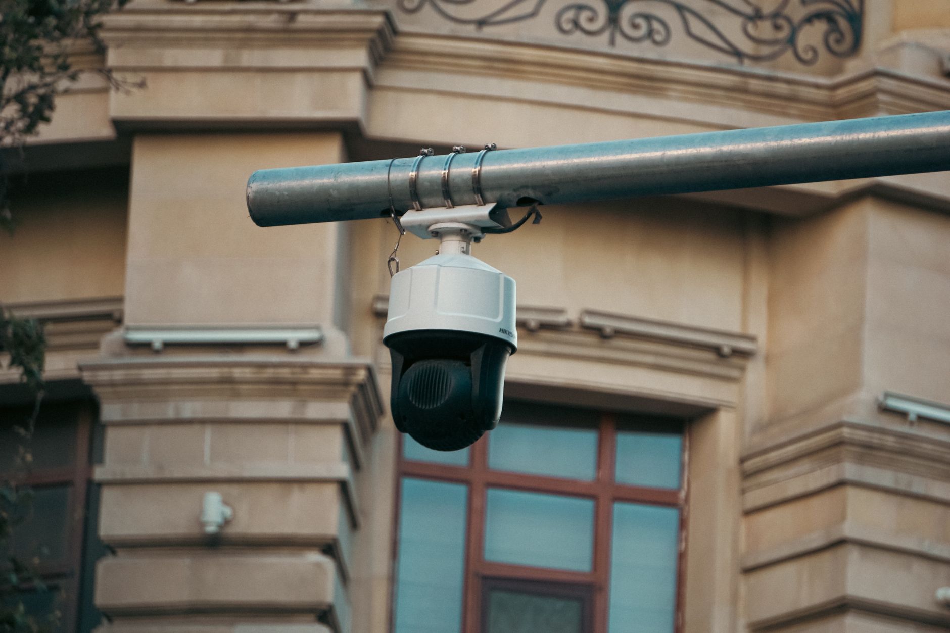Câmera de vigilância inteligente com uma interface futurista em um ambiente urbano, simbolizando o debate sobre a ética da IA e a privacidade.